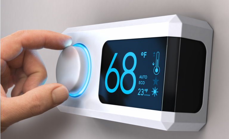 a hand controlling temperature on a thermostat